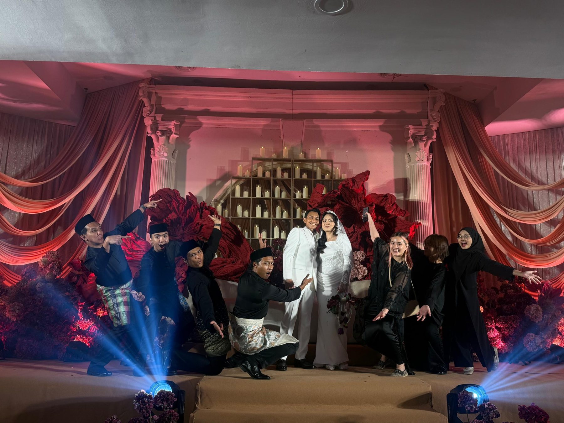 HIAS Acara wedding team and couple on a dramatic floral stage